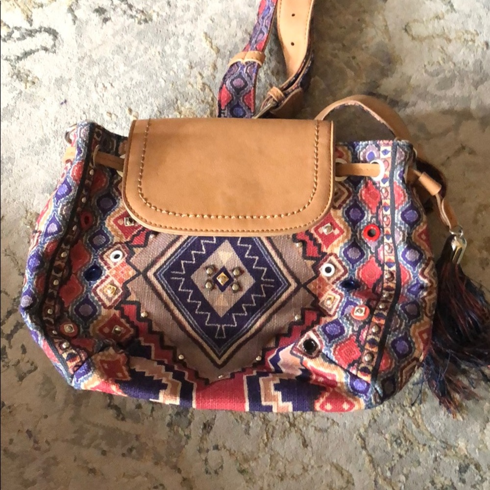 Backpack style purse with tassel